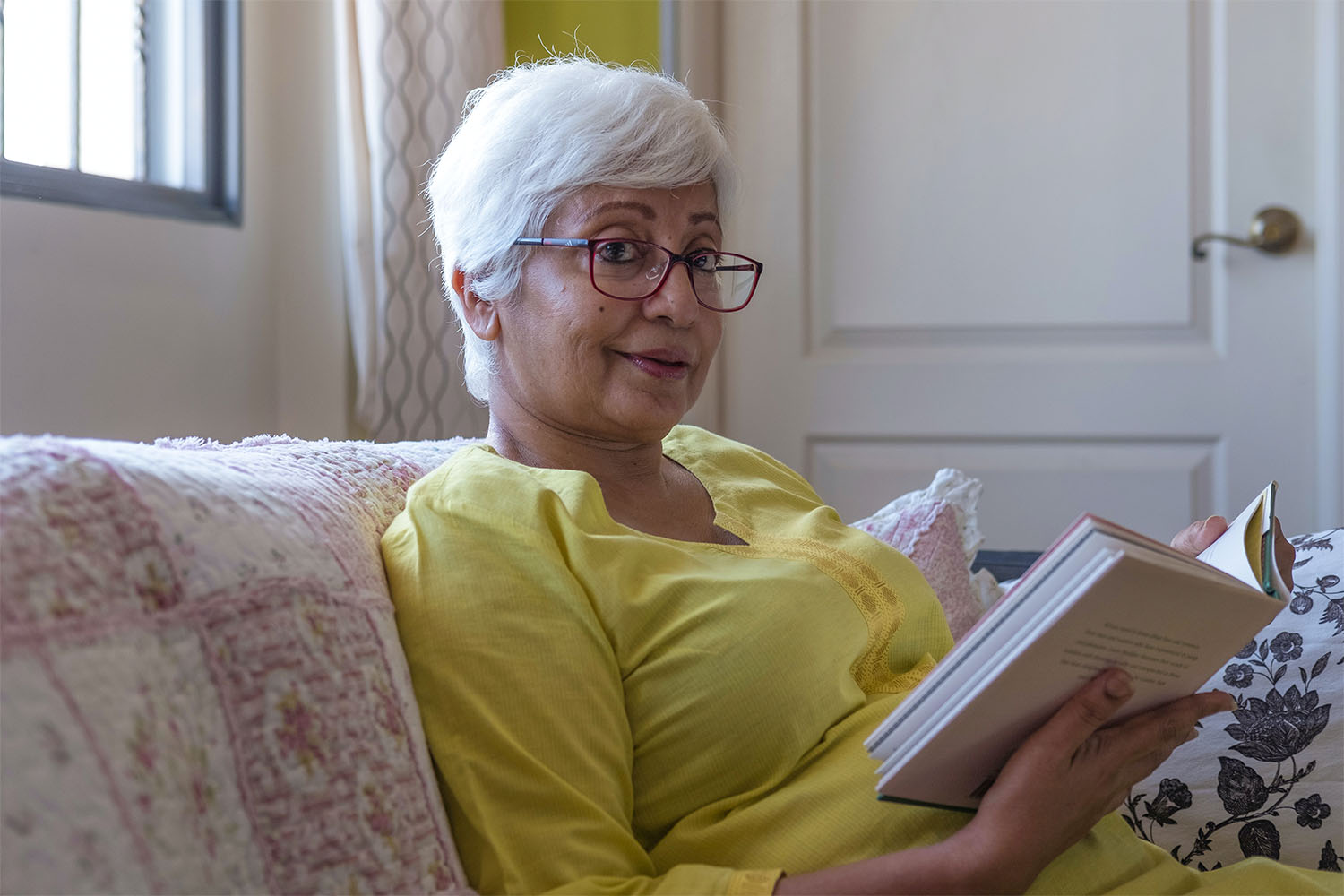 female resident sat reading a book